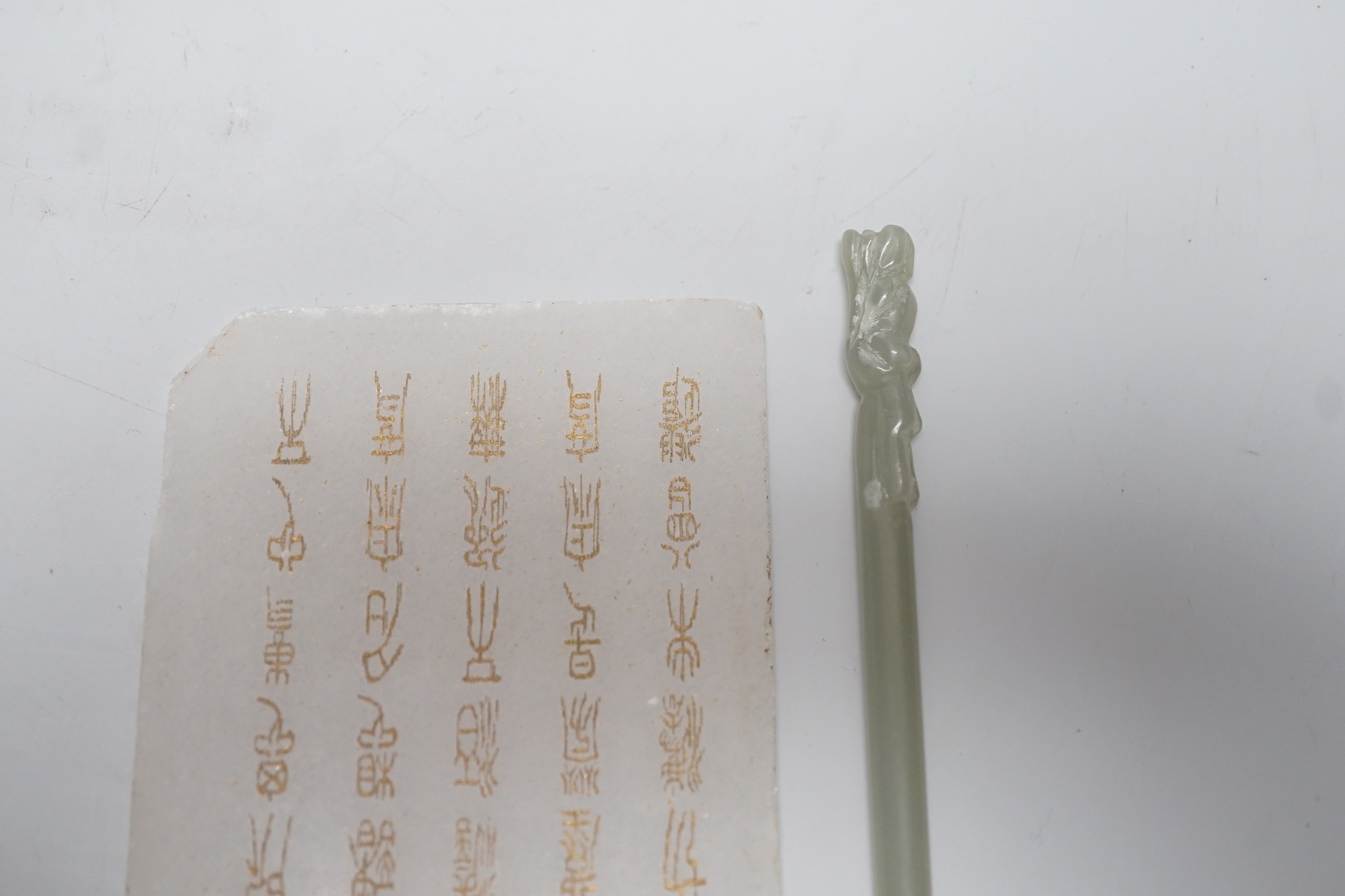A Chinese carved stone tablet, 15.5 x 7.8 cm and a hair pin